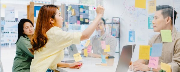 asia-businesspeople-discussing-business-brainstorm-meeting-together-share-data-write-acrylic-partition-stand-back-new-normal-office-lifestyle-social-distancing-work-after-coronavirus-1.jpg