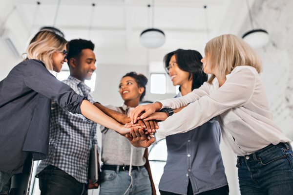 cheerful-international-students-with-happy-face-expression-going-work-together-science-project-indoor-photo-blonde-woman-trendy-blouse-holding-hands-with-coworkers.jpg